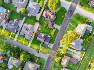 Aerial view of a residential neighborhood in Argyle with well-maintained trees and landscapes, emphasizing the importance of professional arborist services.
